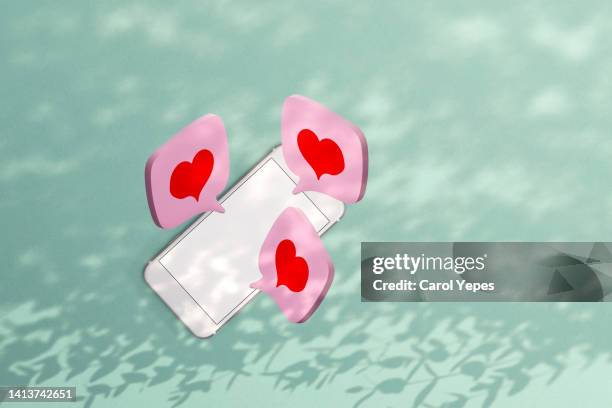 speech bubble with pink heart shape made of paper work in a smartphone.communication - facebook like stock pictures, royalty-free photos & images