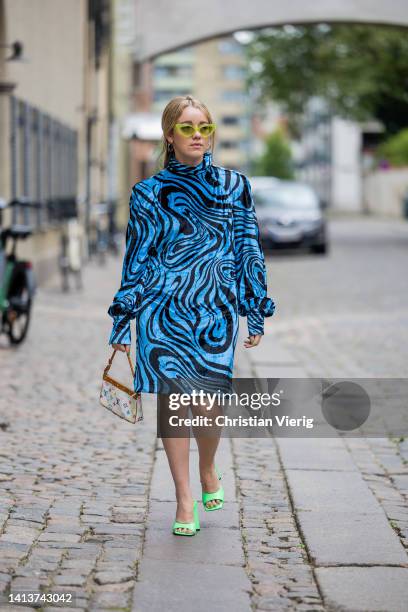 Joicy Muniz is seen wearing blue Dress with zebra print: Philosophy di Lorenzo Serafini, Sunglasses: The Attico, Bag: Louis Vuitton, neon green...