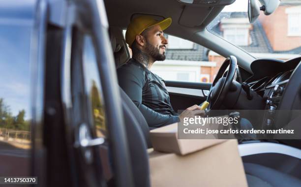 package delivery man, driving, delivery of boxes and merchandise, logistics, small business owner, self-employed - delivery boy stock-fotos und bilder