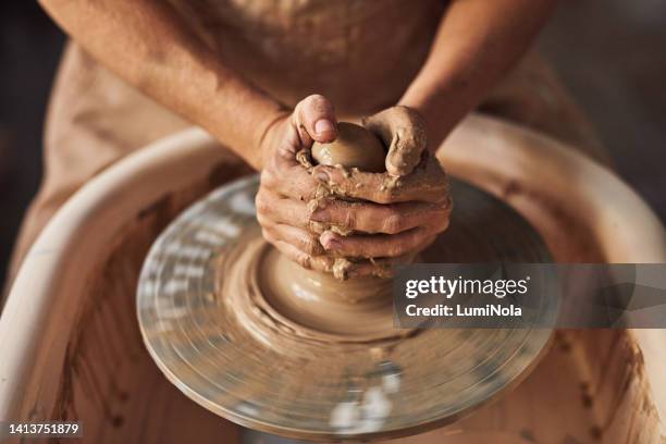 closeup of an artistic and creative woman's hands making pottery in a designer studio workshop. a professional artist sculpting and shaping clay into a handmade vase using traditional equipment - clay pot making stock pictures, royalty-free photos & images