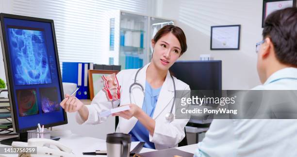 doctor explain rectum model - anal stock pictures, royalty-free photos & images