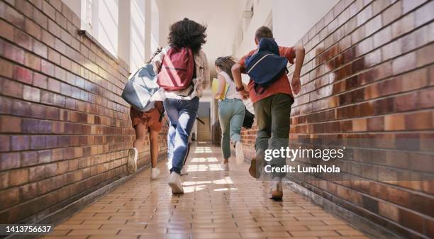 fun, happy and excited school students running, racing and rushing down a school hallway to break or recess. rearview of a group of diverse and playful children sprinting to play with their friends - school run stock pictures, royalty-free photos & images