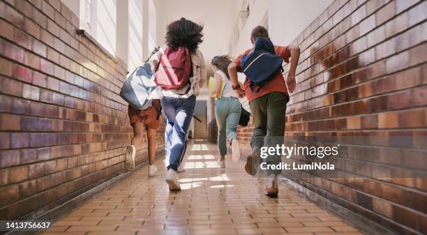 fun, happy and excited school students running, racing and rushing down a school hallway to break or recess. rearview of a group of diverse and playful children sprinting to play with their friends - day 10 imagens e fotografias de stock