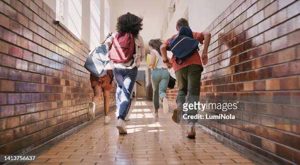 fun, happy and excited school students running, racing and rushing down a school hallway to break or recess. rearview of a group of diverse and playful children sprinting to play with their friends - schoolyard 個照片及圖片檔