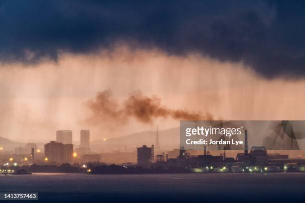 dramatic sunrise and rain over industrial area - duisburg stock pictures, royalty-free photos & images