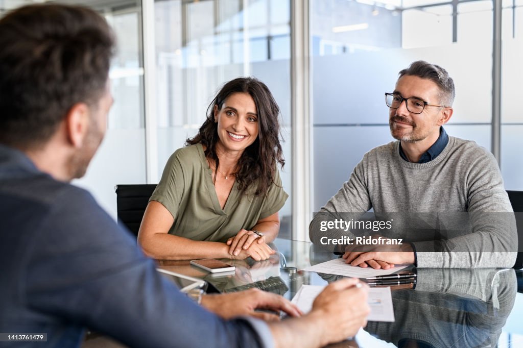 Mature couple meeting financial advisor for investment