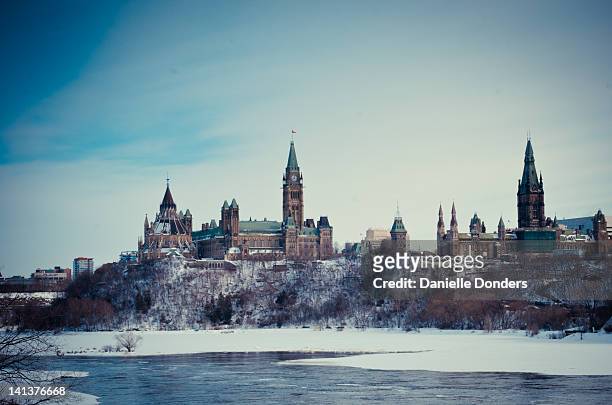canadian parliament hill by ottawa river - ottawa parliament building stock pictures, royalty-free photos & images