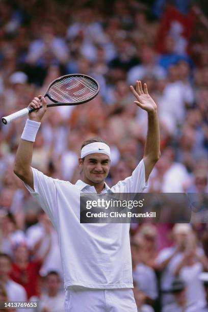 Roger Federer from Switzerland raises his arms in celebration after defeating Pete Sampras of the United States in their Men's Singles Fourth Round...