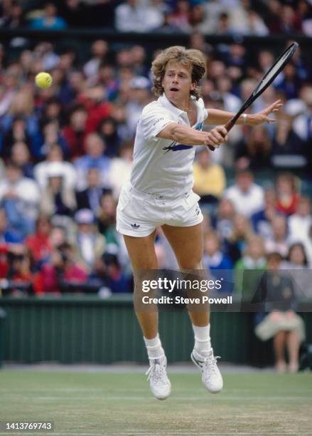 Stefan Edberg from Sweden jumps to play a back hand return to Boris Becker of Germany during their Men's Singles Final match at the Wimbledon Lawn...
