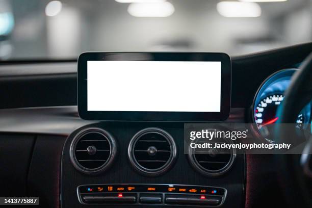 a digital display screen on the dashboard of a modern car - car dashboard foto e immagini stock
