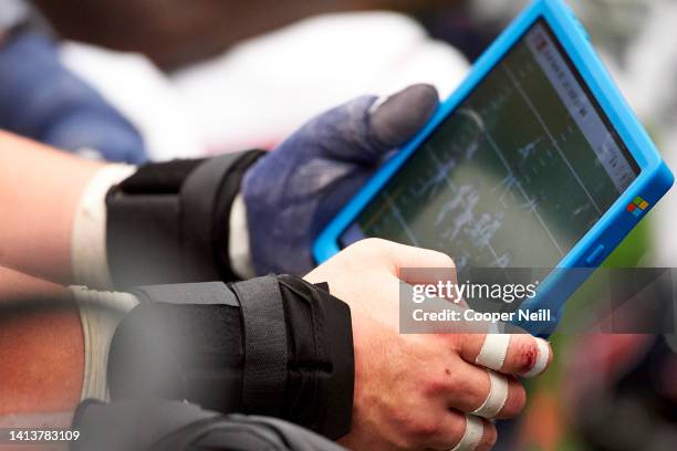 Player on the Houston Texans looks at a Microsoft Surface tablet on the sideline during an NFL football game against the Jacksonville Jaguars,...