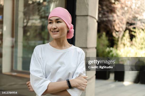 portrait of an asian cancer patient enjoying a city walk - head tie stock pictures, royalty-free photos & images