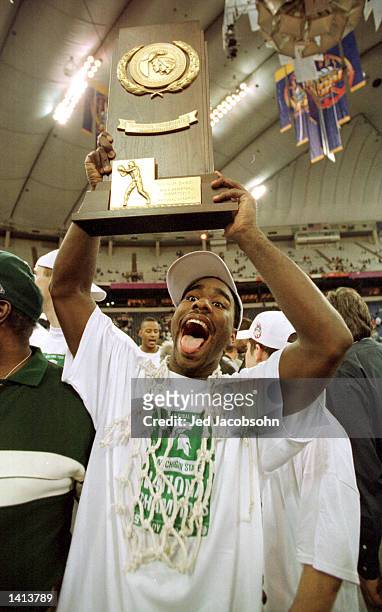 Mateen Cleaves of Michigan State celebrates with the National Championship trophy after his team defeated Florida 89-76 in the championship game at...