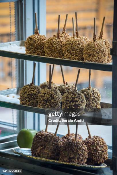 caramel apples on sale at candy store - close up of chocolates for sale fotografías e imágenes de stock