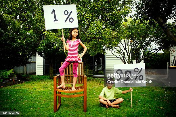 girl and boy with percentage sign board - kids placard stock pictures, royalty-free photos & images