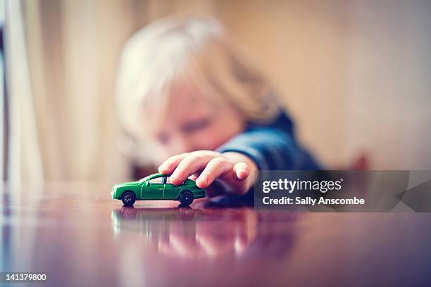 child playing with toy car - children playing with toys imagens e fotografias de stock