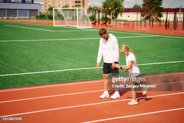 father training daughter at stadium - stadium general view stock pictures, royalty-free photos & images