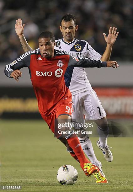 Ryan Johnson of Toronto FC attacks while being pursued by Juninho of the Los Angeles Galaxy in the first half during a CONCACAF Champions League game...