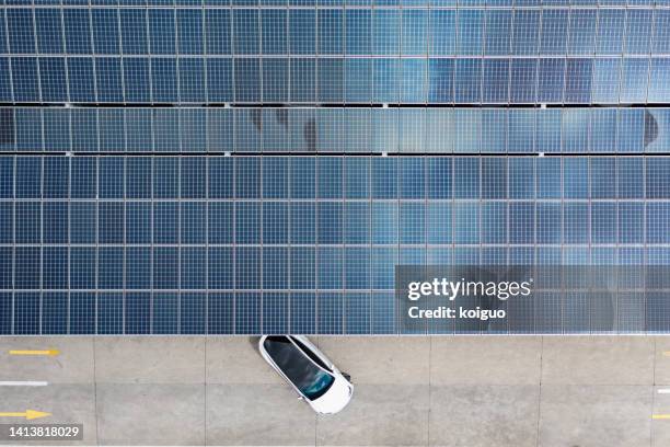 overhead shot of fast charging station for electric vehicles using green energy - solar powered station fotografías e imágenes de stock