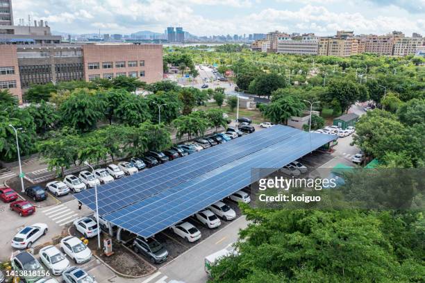 electric vehicle fast charging station using green energy - parkplatz stock-fotos und bilder