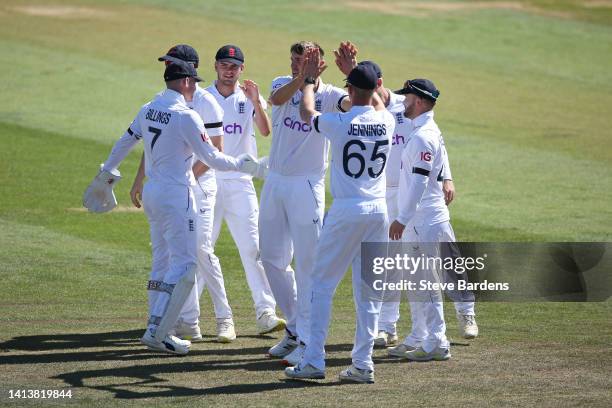 Craig Overton of England Lions celebrates taking the wicket of Aiden Markram of South Africa caught by Sam Billings with his team mates during the...
