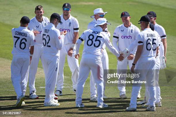 Craig Overton of England Lions celebrates taking the wicket of Ryan Rickelton of South Africa caught by Will Jacks with his team mates during the...