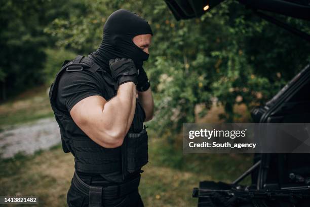 swat team soldier preparing for a mission - bivakmuts stockfoto's en -beelden