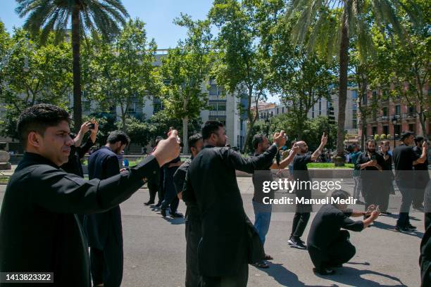 Shiites take photos of how the procession progresses in the city center on August 9, 2022 in Barcelona, Spain. Shiite Muslim men, women and children...