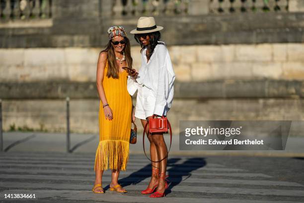 Alba Garavito Torre wears a brown with camel and white print pattern silk scarf as a head band from Lollys Laundry, black sunglasses from Ray Ban,...