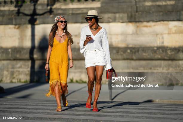 Alba Garavito Torre wears a brown with camel and white print pattern silk scarf as a head band from Lollys Laundry, black sunglasses from Ray Ban,...