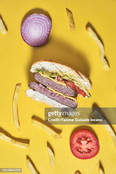 full hamburger on yellow background - fondo amarillo stock pictures, royalty-free photos & images