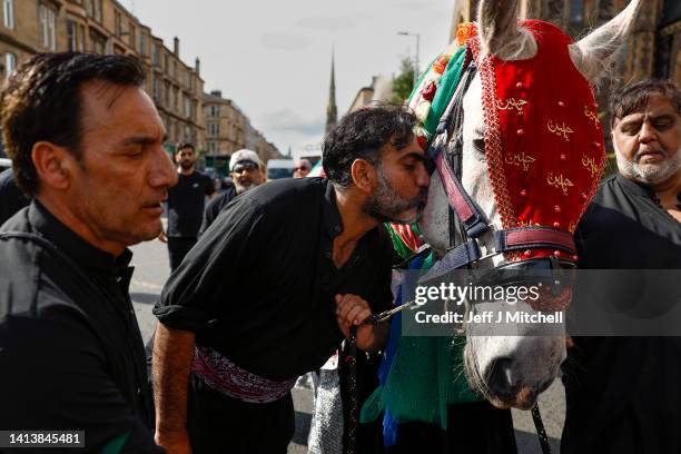 Muslim men chant during the Ashura festival procession through Glasgow on August 09, 2022 in Glasgow, Scotland. Ashura is a day of atonement for...