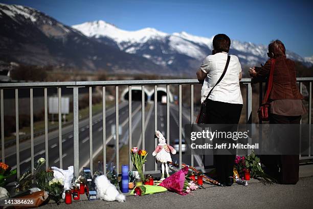 Members of the public lay flowers on a bridge near to the road tunnel where the 22 Belgian school children, four teachers and two drivers died in a...