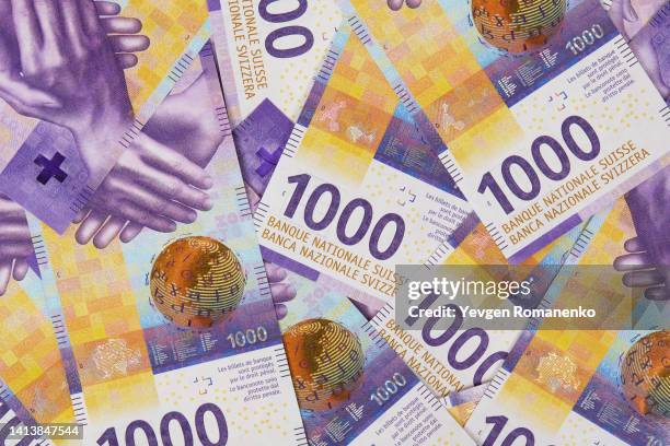 full frame of 1000 swiss francs banknotes as a background - swiss money stockfoto's en -beelden