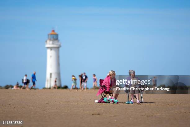 People enjoy the warm weather and sunshine on New Brighton beach and promenade on August 09, 2022 in New Brighton, United Kingdom. The Met Office,...