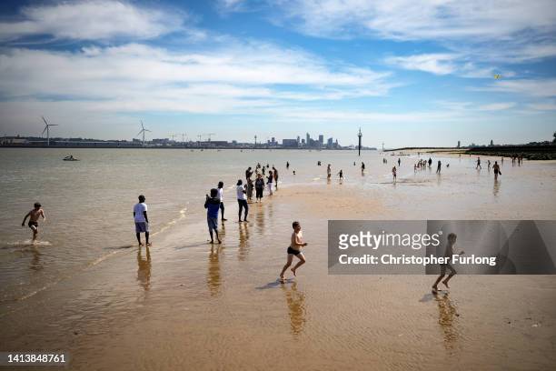 People enjoy the warm weather and sunshine on New Brighton beach and promenade on August 09, 2022 in New Brighton, United Kingdom. The Met Office,...