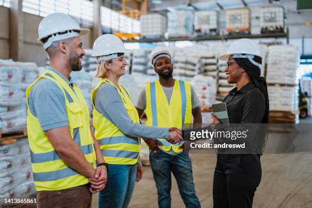 work team in factory warehouse - sports venue employee stock pictures, royalty-free photos & images
