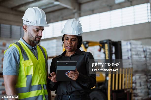 manager checking the stock in the warehouse - inspectors stock pictures, royalty-free photos & images