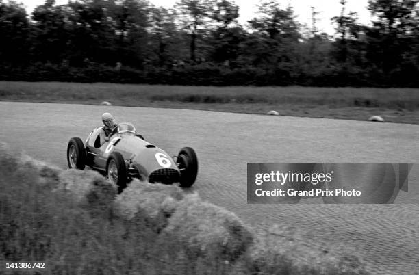 Alberto Ascari of Italy drives the Scuderia Ferrari Ferrari 375 Ferrari V12 of team mate Jose Froilan Gonzalez during practice for the Italian Grand...