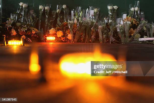 Floral tributes and candles laid by the families at the scene in the road tunnel where the 22 Belgian school children, four teachers and two drivers...