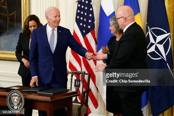 President Joe Biden congratulates Swedish Ambassador Karin Ulrika Olofsdotter and Finnish Ambassador Mikko Hautala after signing the agreement for...