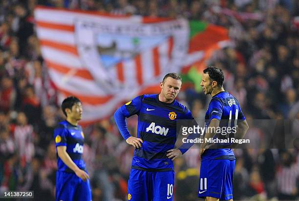 Ji-Sung Park, Wayne Rooney and Ryan Giggs of Manchester United look dejected after conceding a second goal during the UEFA Europa League Round of 16...