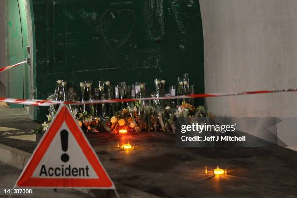 Floral tributes and candles laid by the families at the scene in the road tunnel where the 22 Belgian school children, four teachers and two drivers...