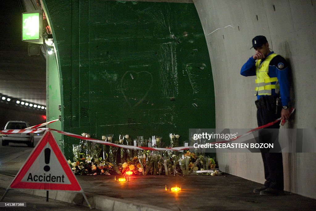 A policeman stand by the flowers left by