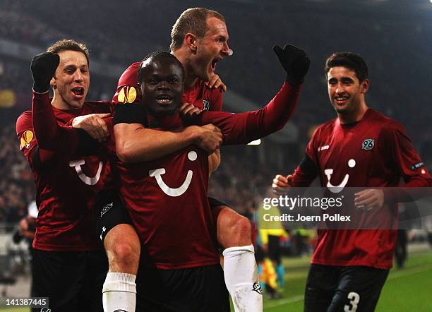 Didier Ya Konan of Hannover celebrates with his team mates after scoring his team's third goal during the UEFA Europa League second leg round of 16...