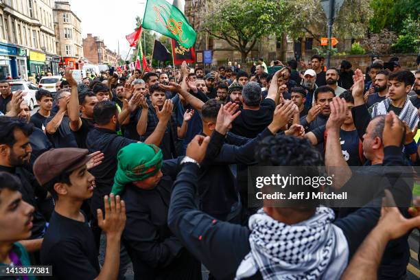 Muslim men chant during the Ashura festival procession through Glasgow on August 09, 2022 in Glasgow, Scotland. Ashura is a day of atonement for...