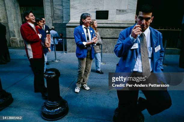 Traders take a break outside The New York Stock Exchange on February 16 at Wall Street in New York, USA.
