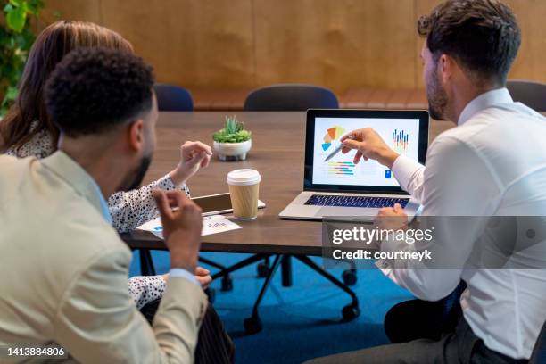 financial advisor or lawyer with couple explaining options. - couple pointing imagens e fotografias de stock