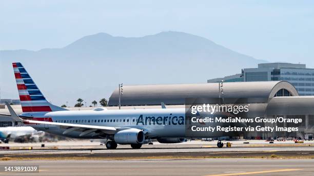August 08: An American Airlines jet at John Wayne Airport in Santa Ana, CA on Monday, August 8, 2022. Saddleback Mountain, part of the Santa Ana...