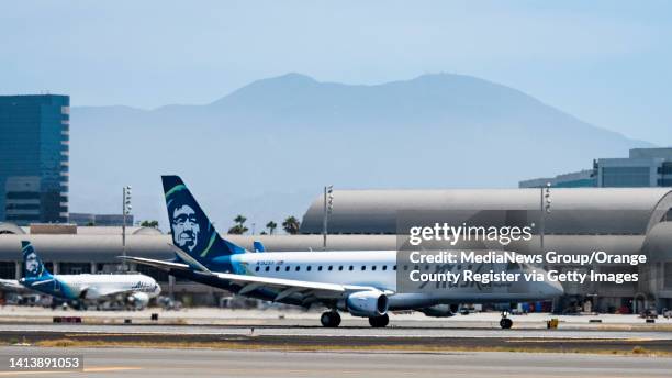 August 08: An Alaska Airlines jet departs John Wayne Airport in Santa Ana, CA on Monday, August 8, 2022. Saddleback Mountain, part of the Santa Ana...